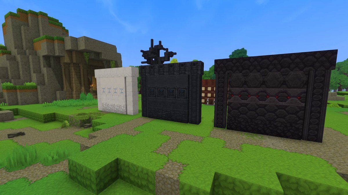 Hytale screenshot: three wall segments of white chalk, dark slate and cooled magma bricks on a meadow