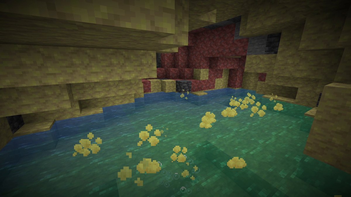 An underground cave with yellow sulfur and red cinnabar walls around a green pool