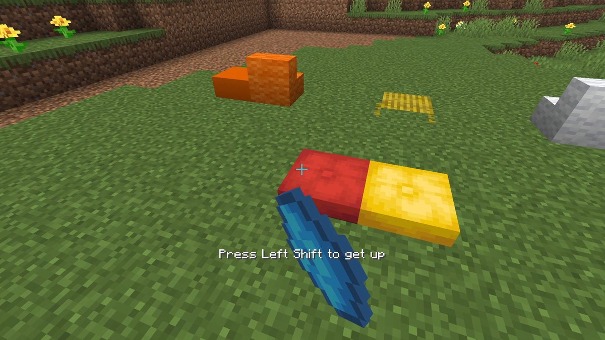 Red and yellow cushions, orange wool stairs and a straw bed on grass