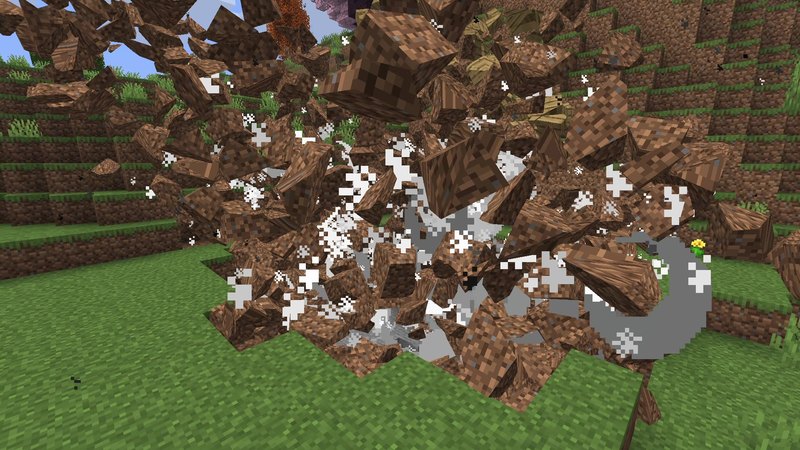 Minecraft screenshot of a TNT explosion with Physics Mod: chunks of dirt and planks fly through the air in front of a hillside