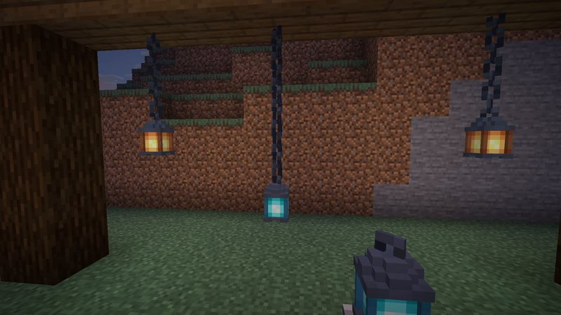 Split Minecraft screenshot of hanging lanterns on chains at dusk: left half vanilla, right half with the Better Lanterns resource pack