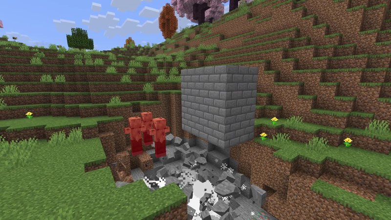 Minecraft screenshot of a stone brick block next to broken stone pieces on the ground and three red, hurt mobs tipping over