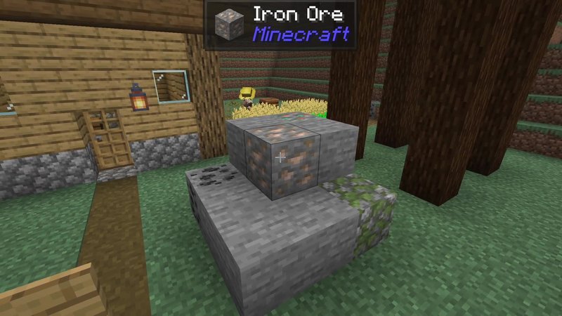 Minecraft 26.3 screenshot of an iron ore block next to a wooden house, with the Jade panel at the top reading Iron Ore, Minecraft