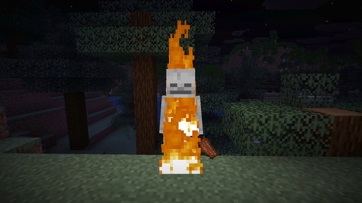 Minecraft screenshot at night of a burning skeleton lighting up the grass and trees around it