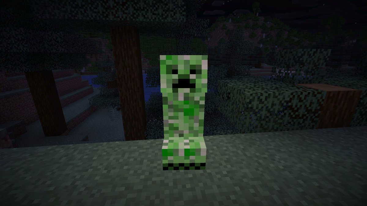 Minecraft screenshot at night of a swelling creeper in front of trees