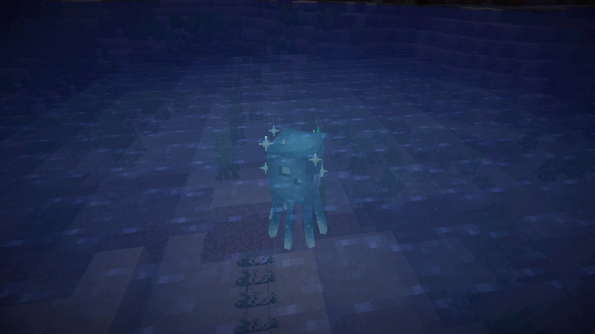 Minecraft screenshot of a glowing glow squid in a river at night