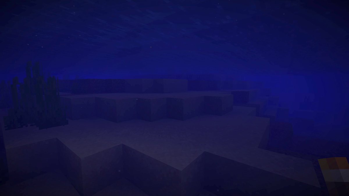 Dark blue underwater Minecraft screenshot with a torch in the player's hand