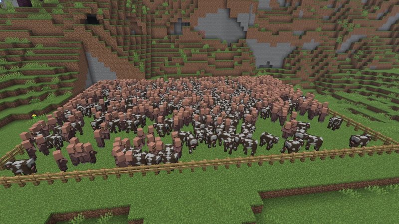 A fenced pen in Minecraft 26.3 packed with hundreds of villagers and cows in front of a hillside
