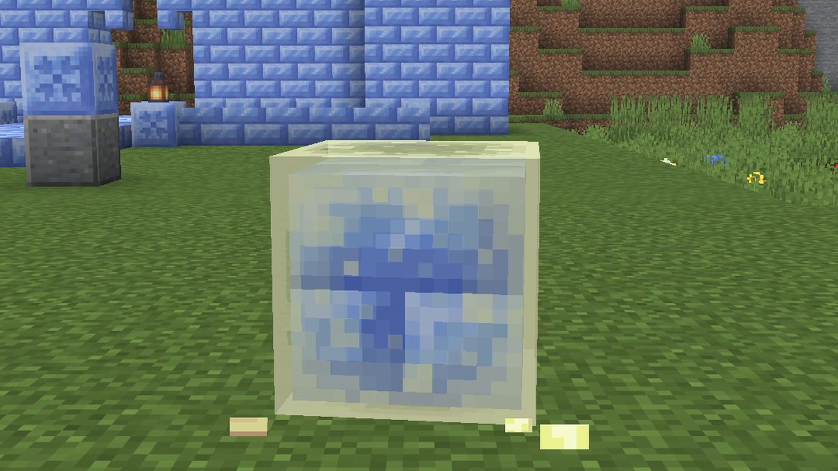 Minecraft screenshot: a translucent Sulfur Cube with a light blue ice block inside on a meadow