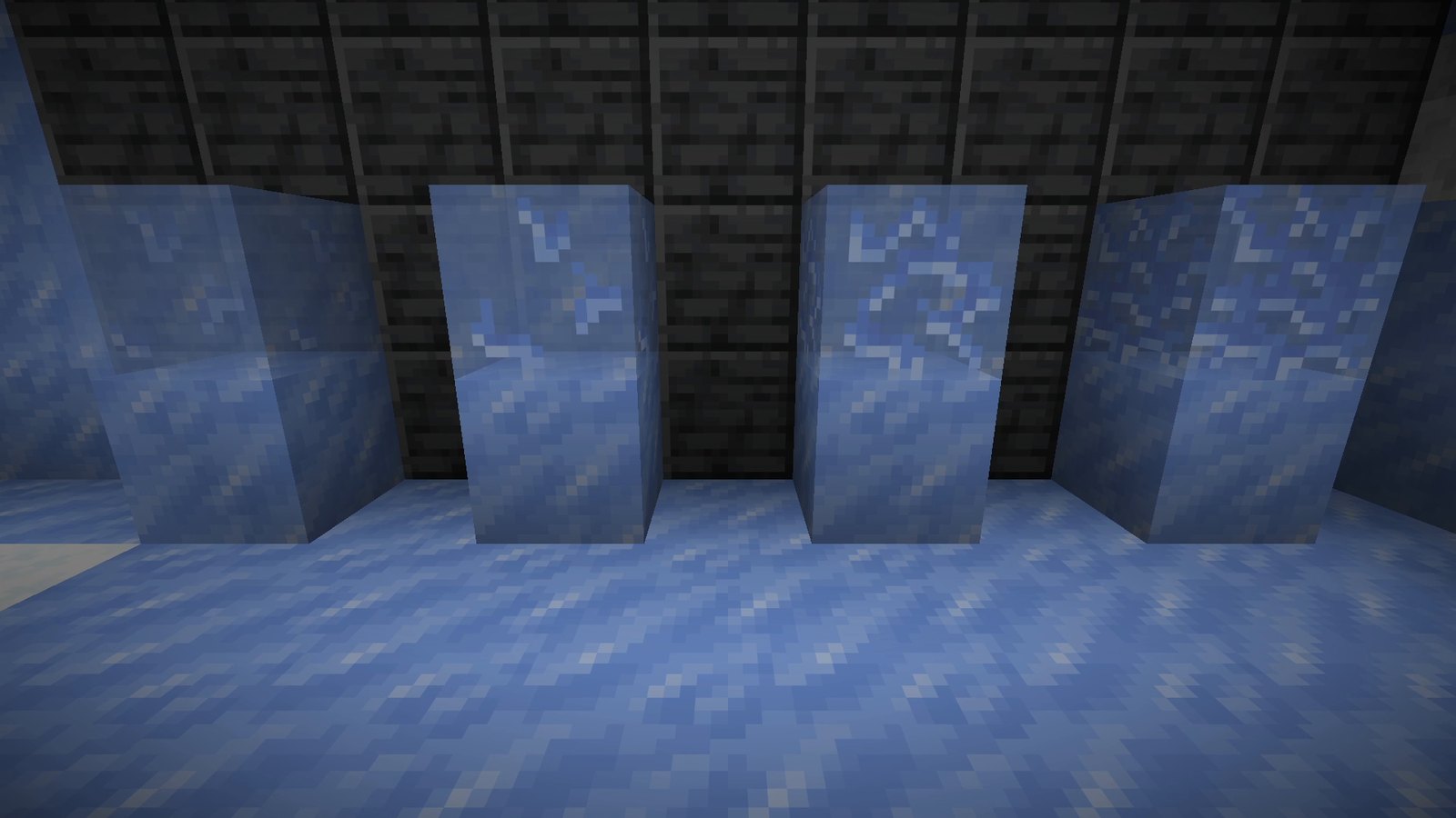 Four Brittle Ice blocks in a row, from no cracks to heavily cracked, in front of a dark stone wall